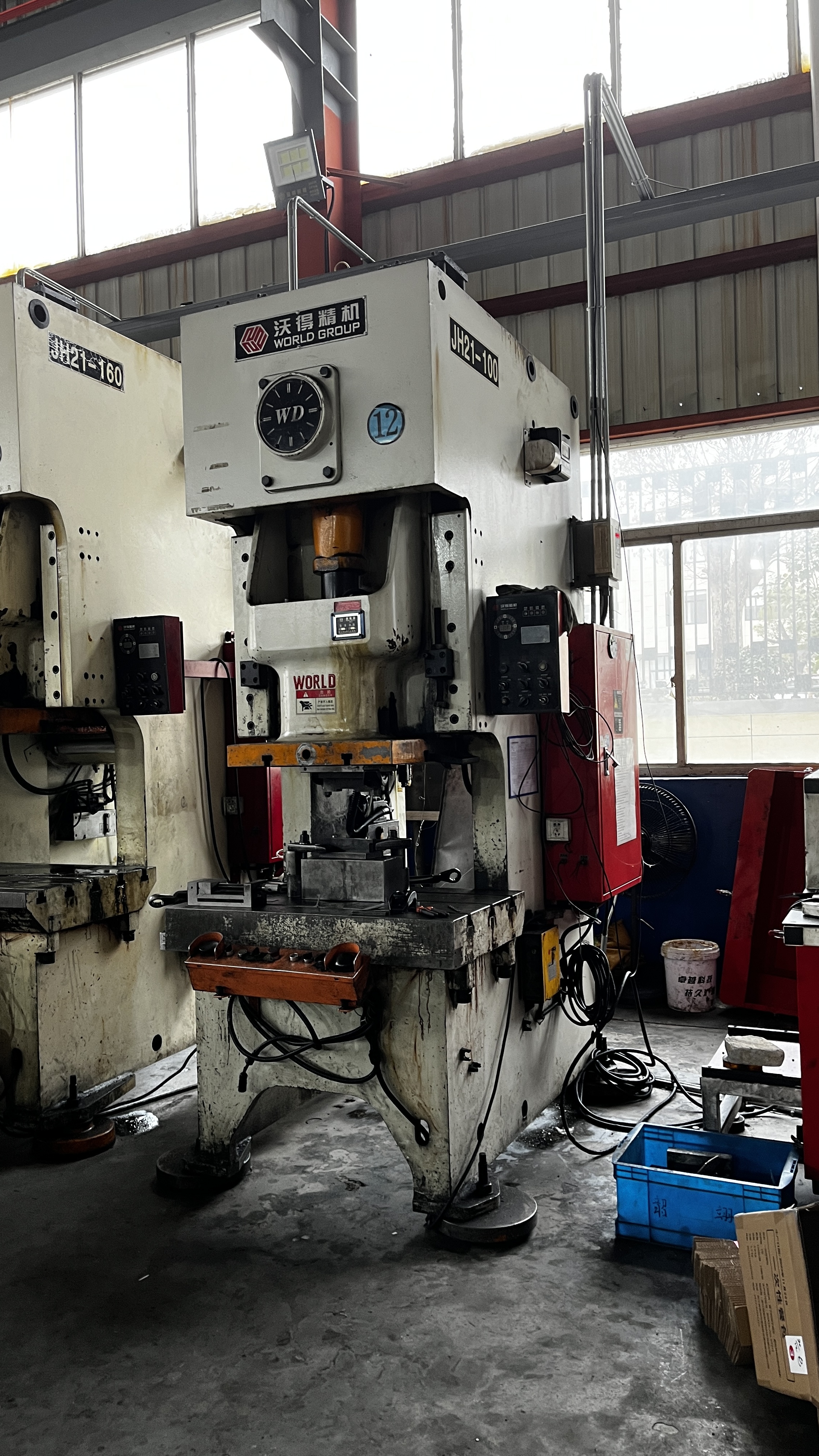 die casting process in action with engineers and finished metal parts