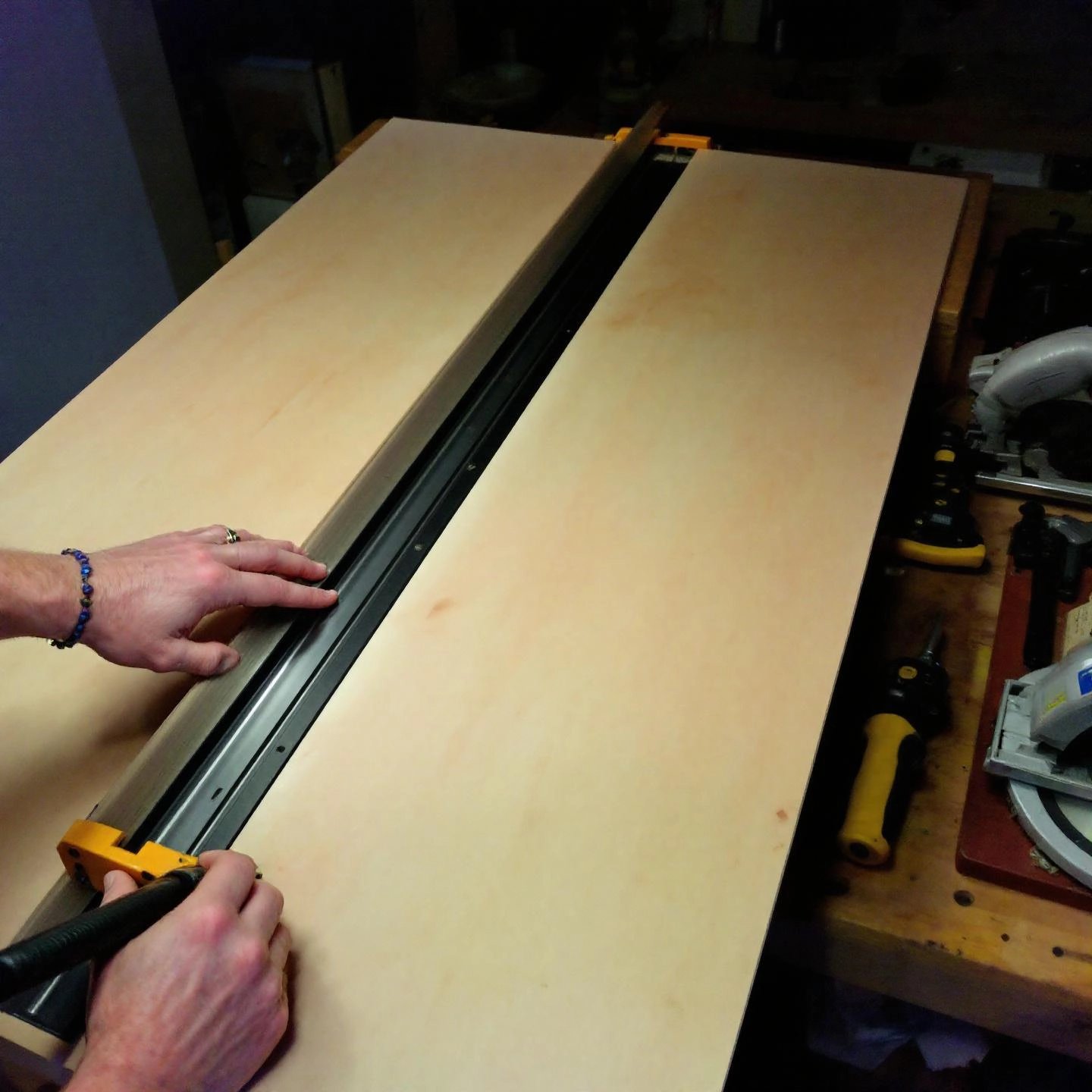 using an aluminum straight edge as a guide for precise straight cuts in woodworking