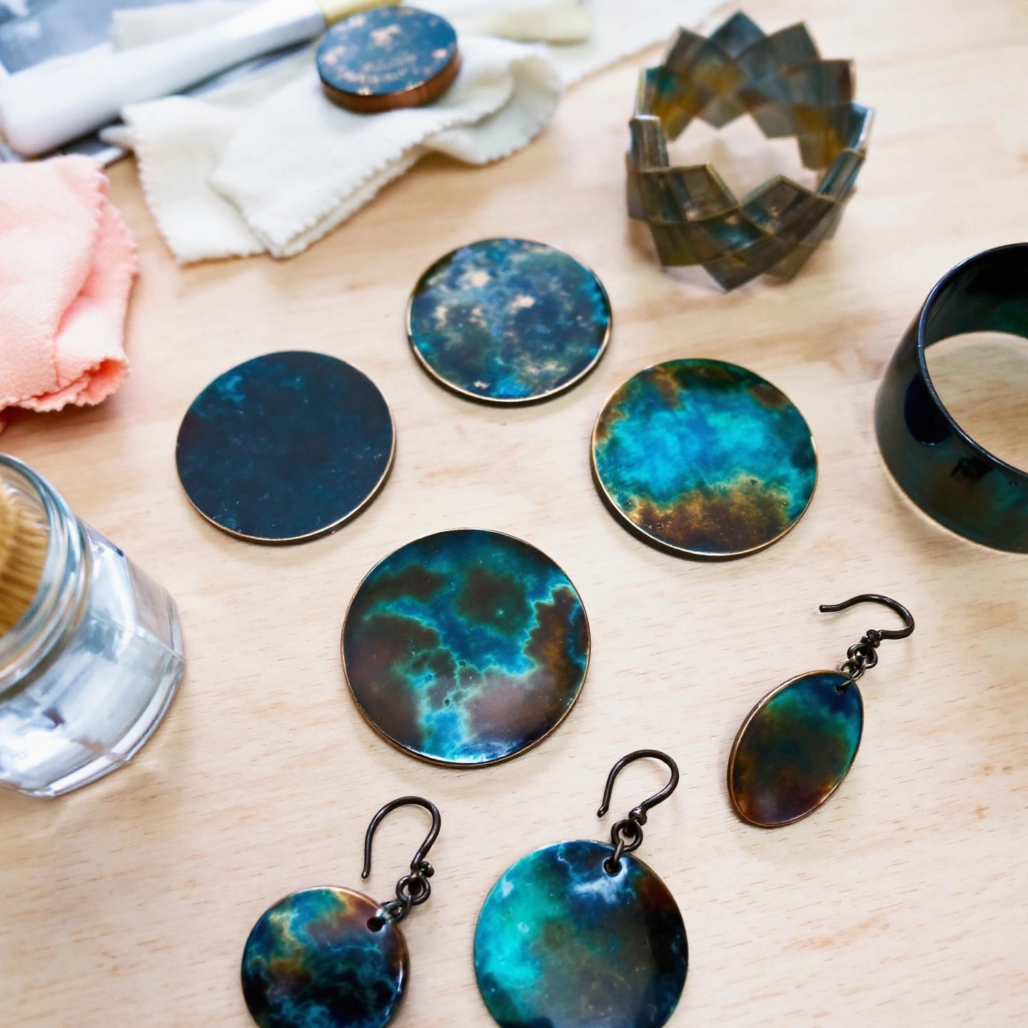 copper jewelry showing both patina and polished finishes alongside basic cleaning tools