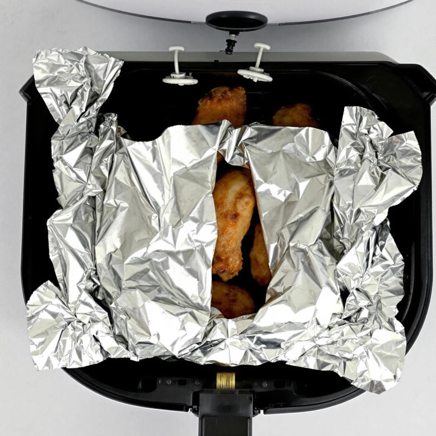 proper aluminum foil placement ensures air fryer safety and even cooking