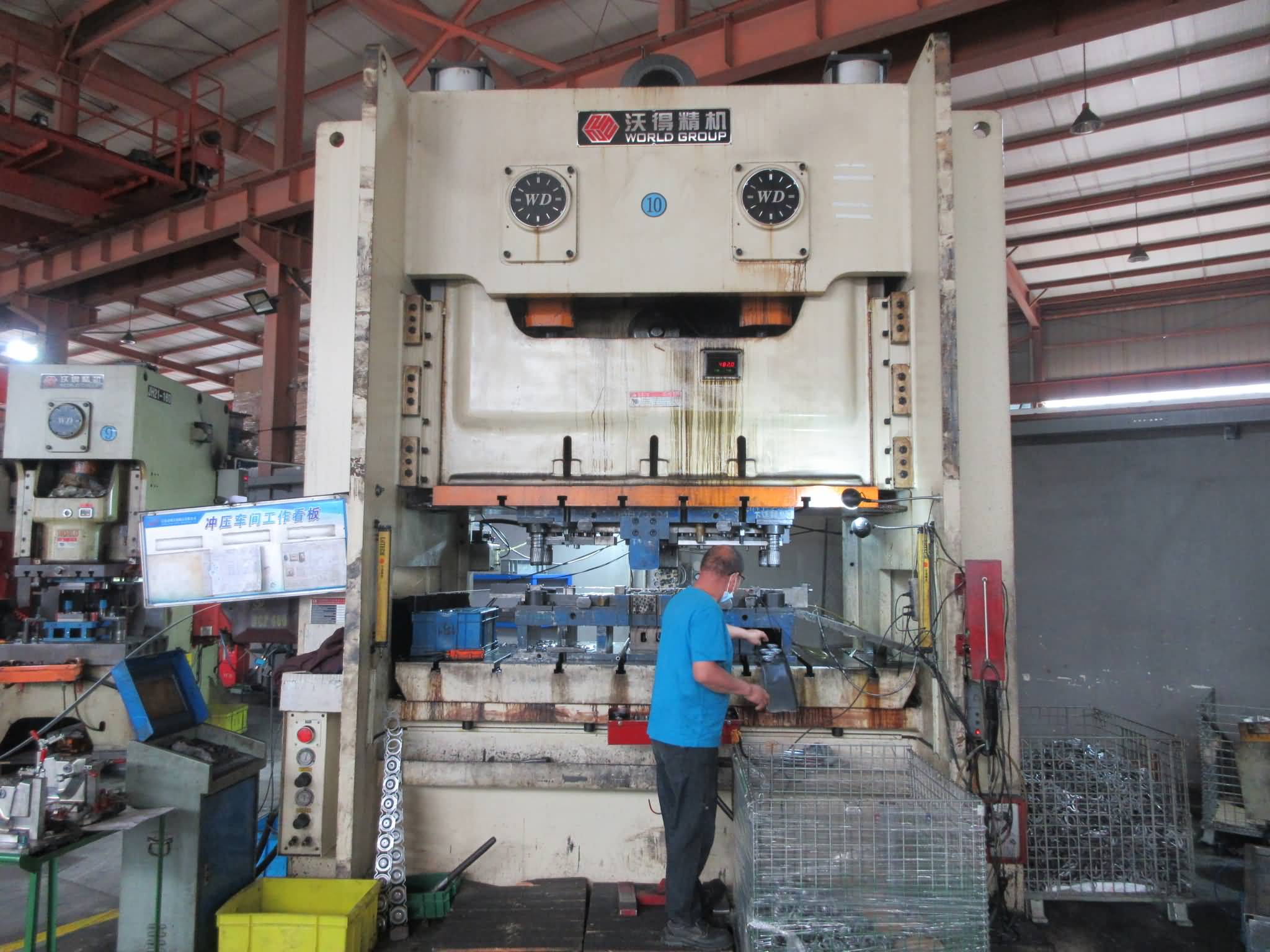 modern stamping press line shaping sheet metal components in a manufacturing plant