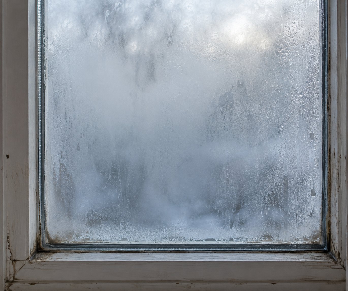 fog trapped between double pane glass signals a failed window seal that requires professional replacement