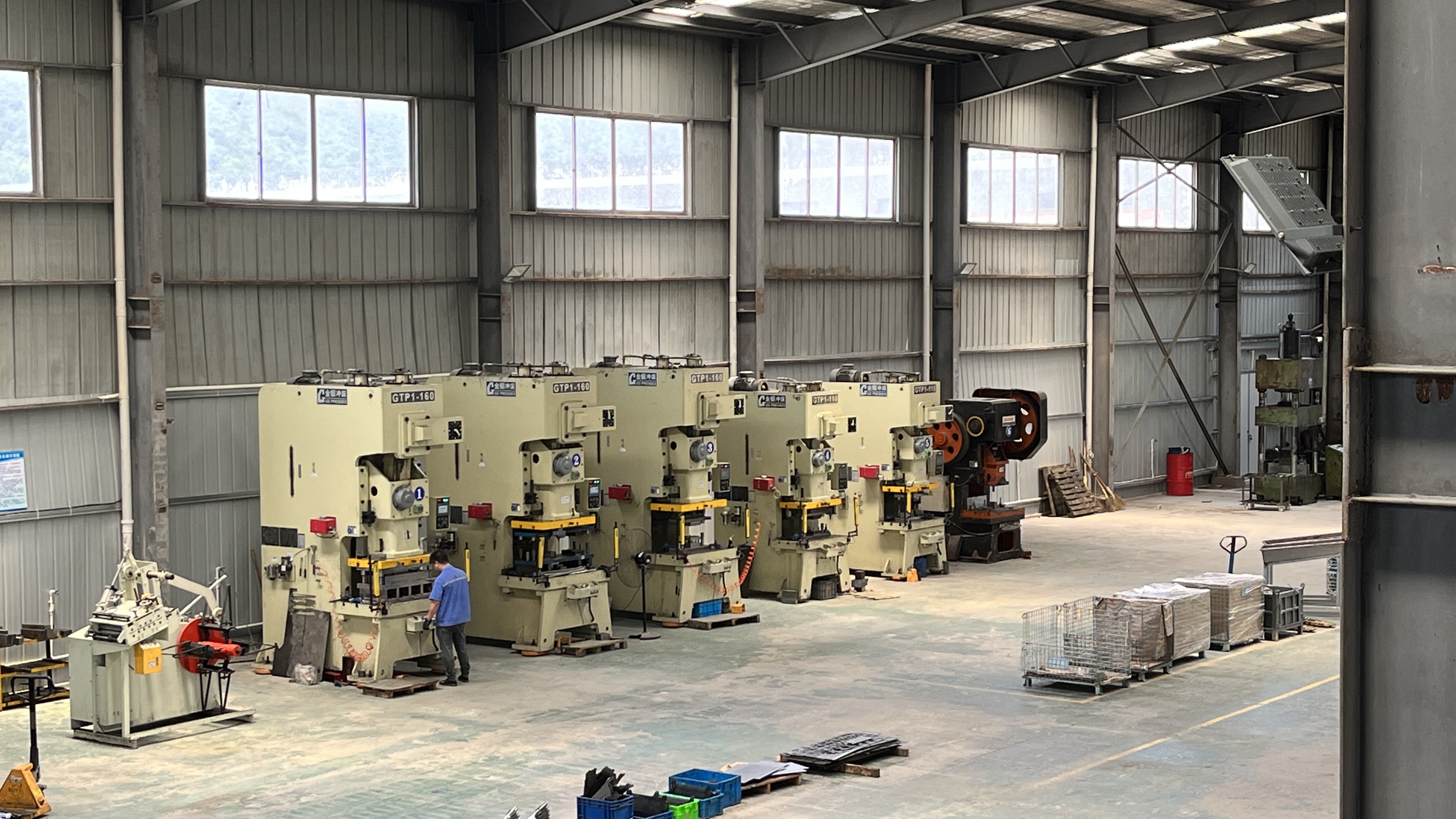 progressive metal stamping line with coil feed and sequential die stations in a modern factory