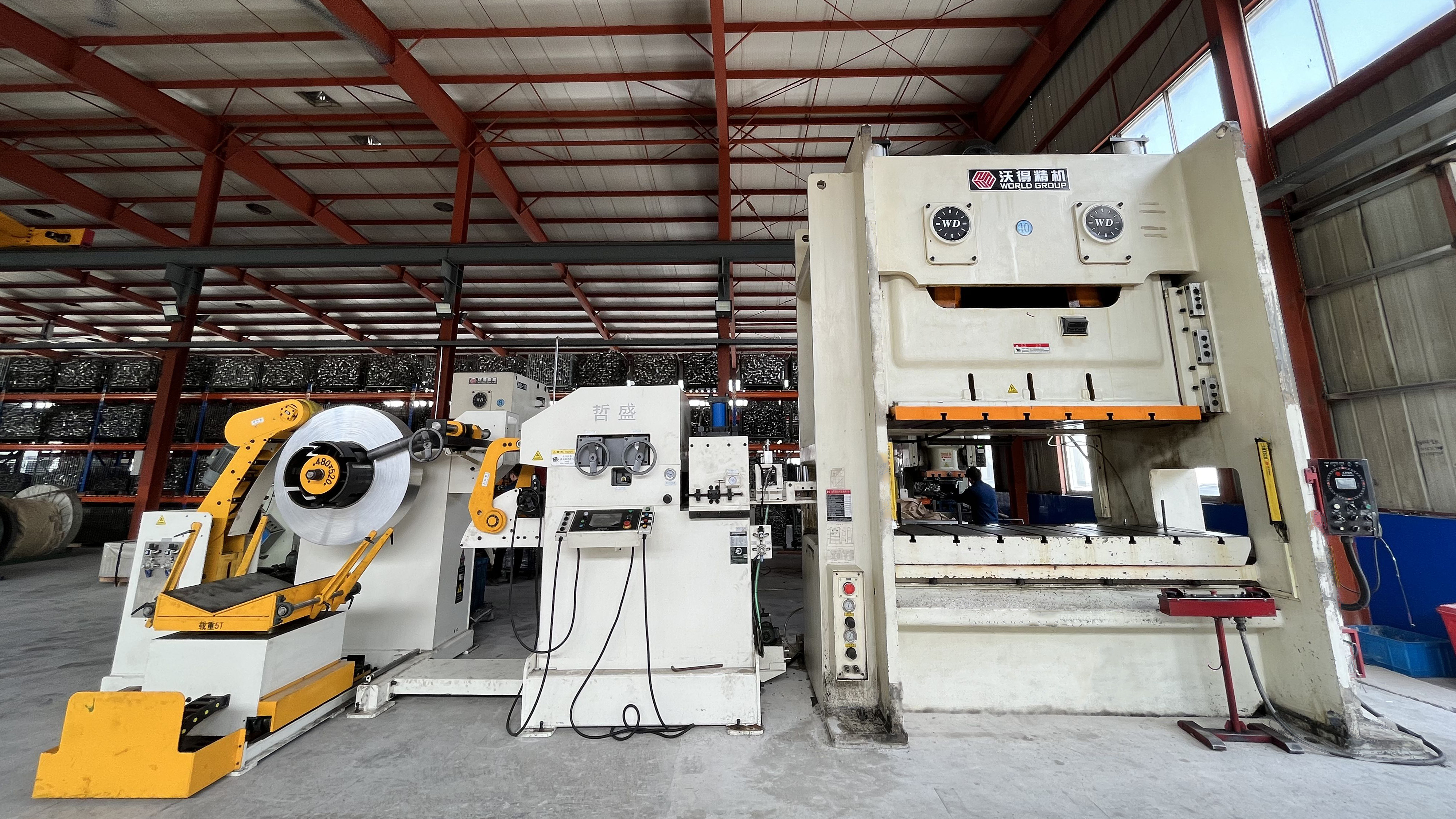 modern metal stamping factory floor with stamping presses and engineers collaborating