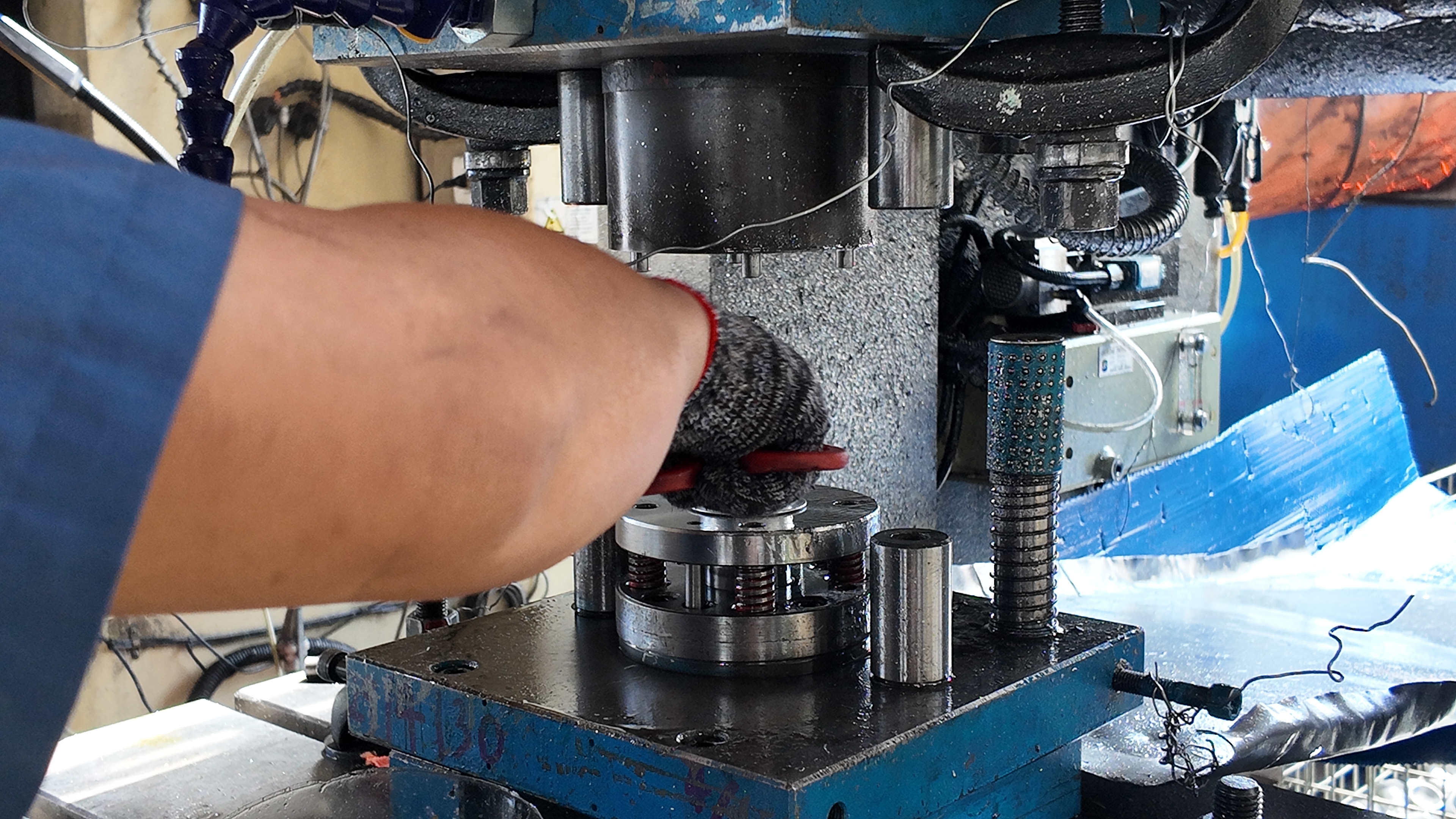 technician performing preventative maintenance on a stamping die set