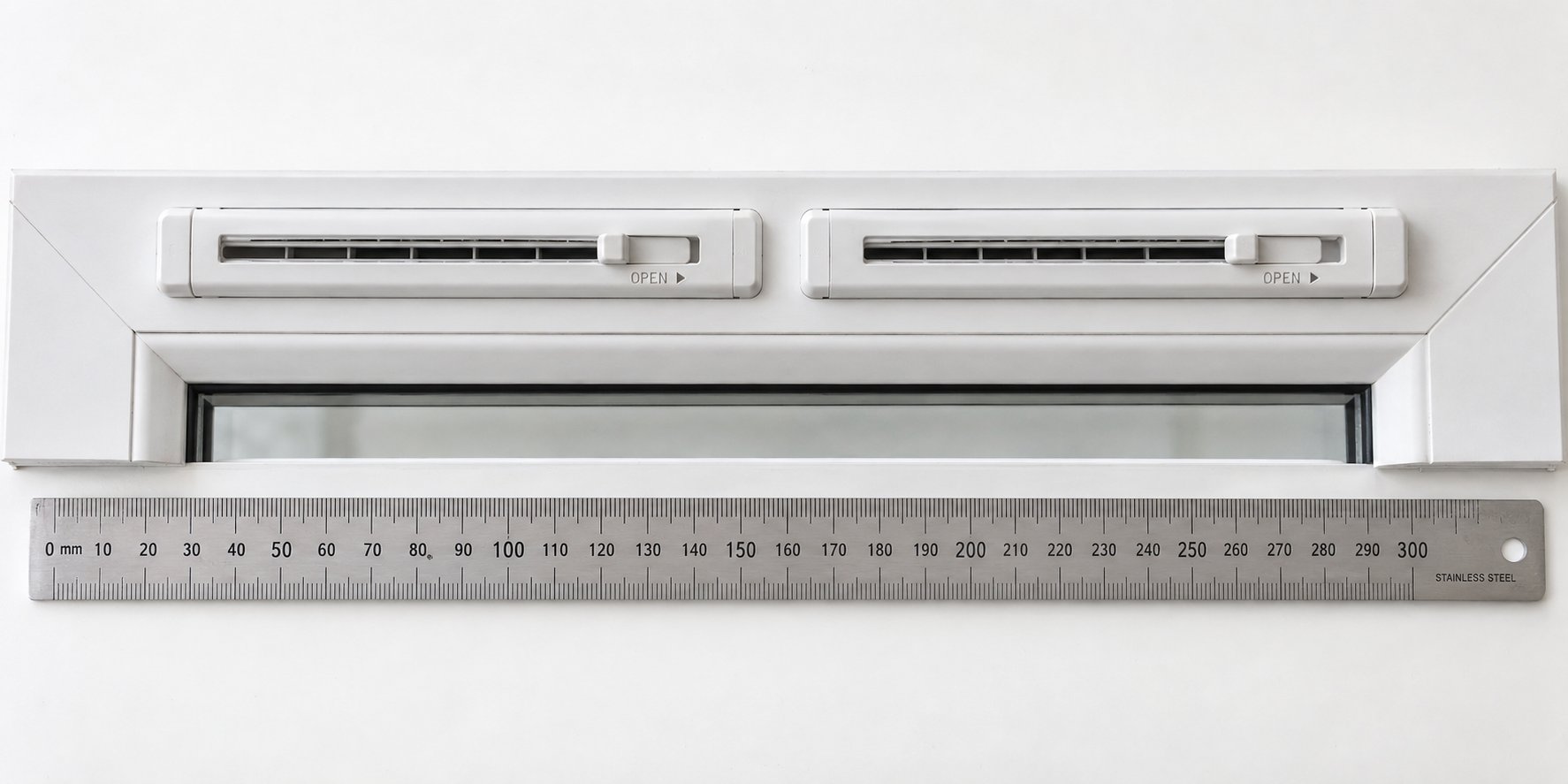 two trickle vents fitted side by side on a single window frame to meet room ventilation requirements