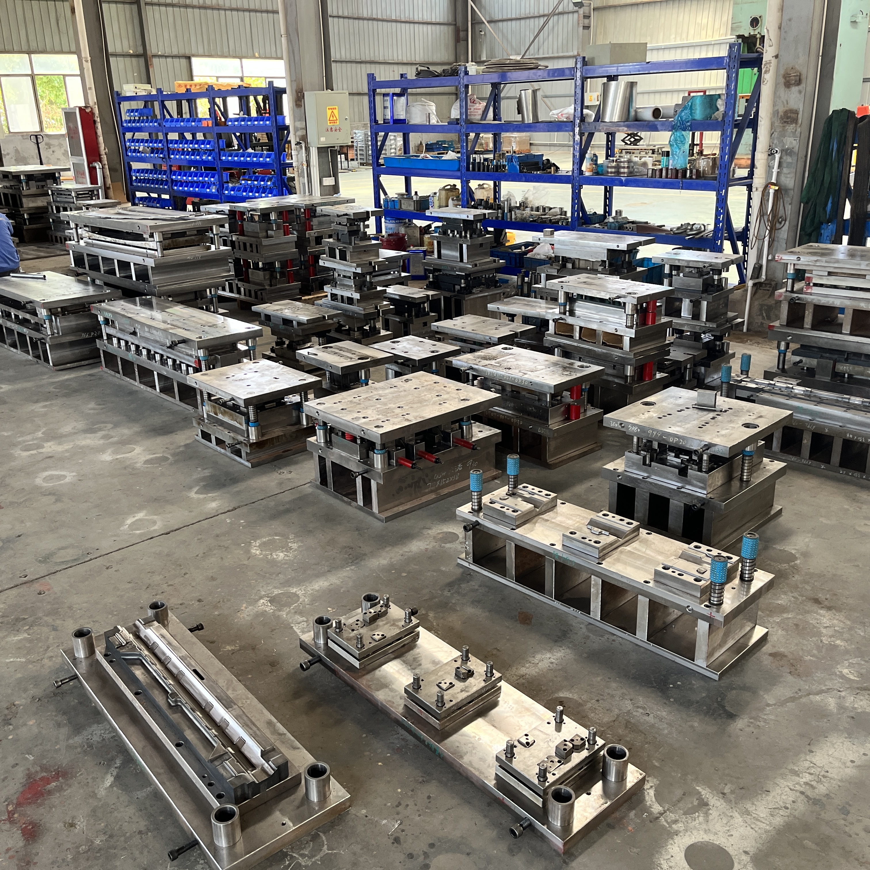 different types of automotive stamping dies in a modern factory setting