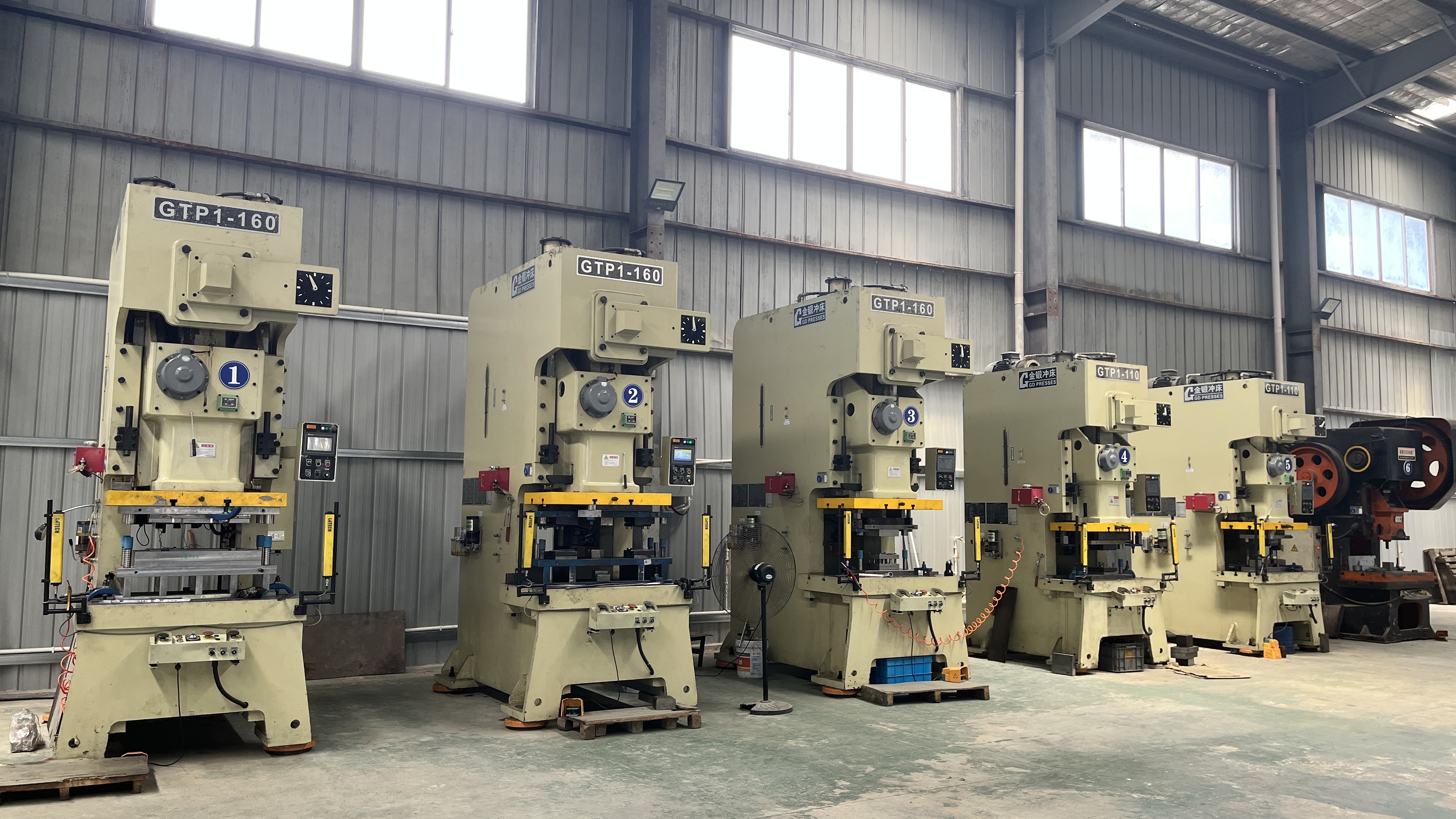 different stamping presses matched to appropriate die types in a factory