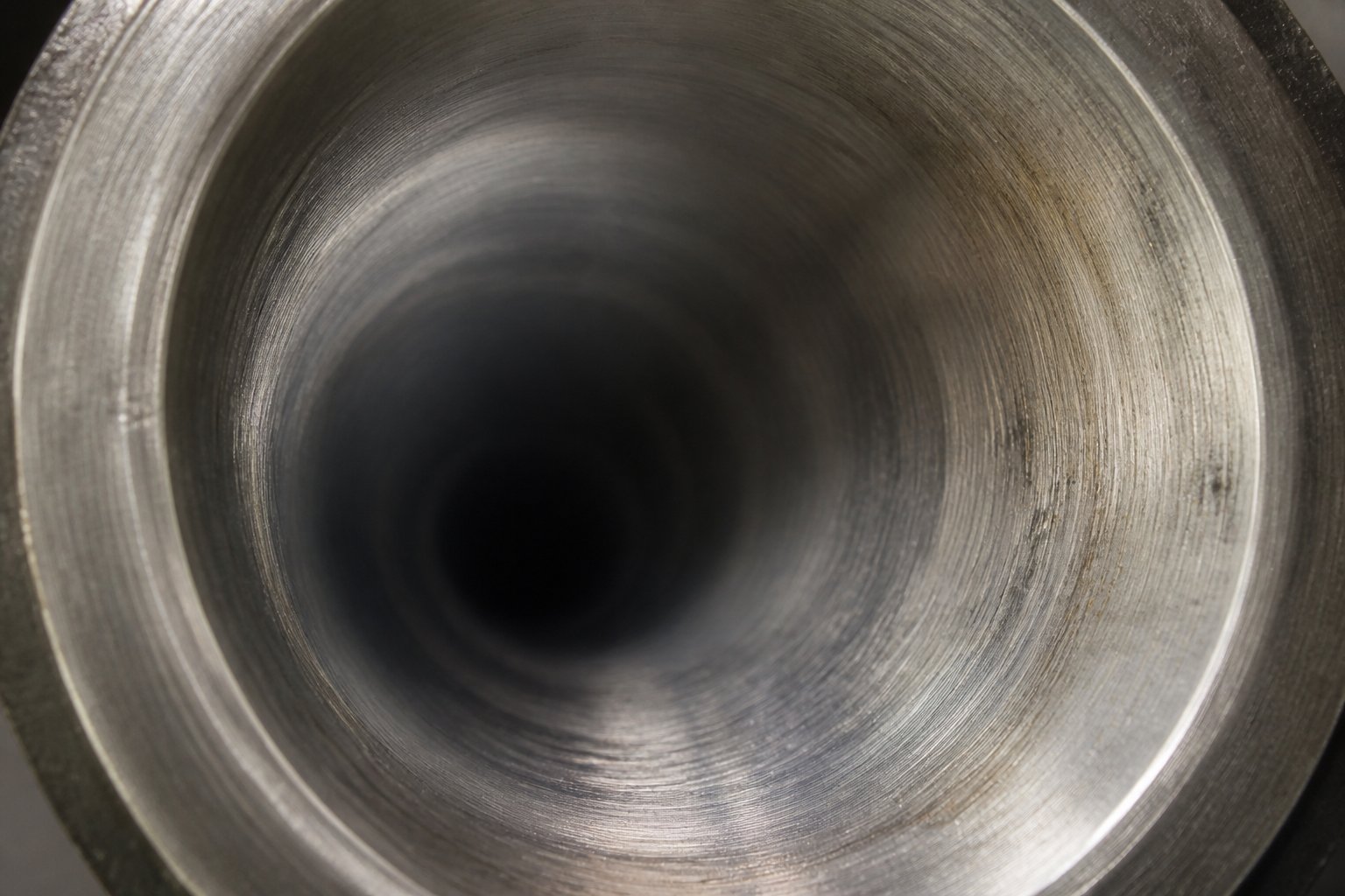 interior bore surface of a twin screw barrel showing wear patterns that develop during extended processing operations