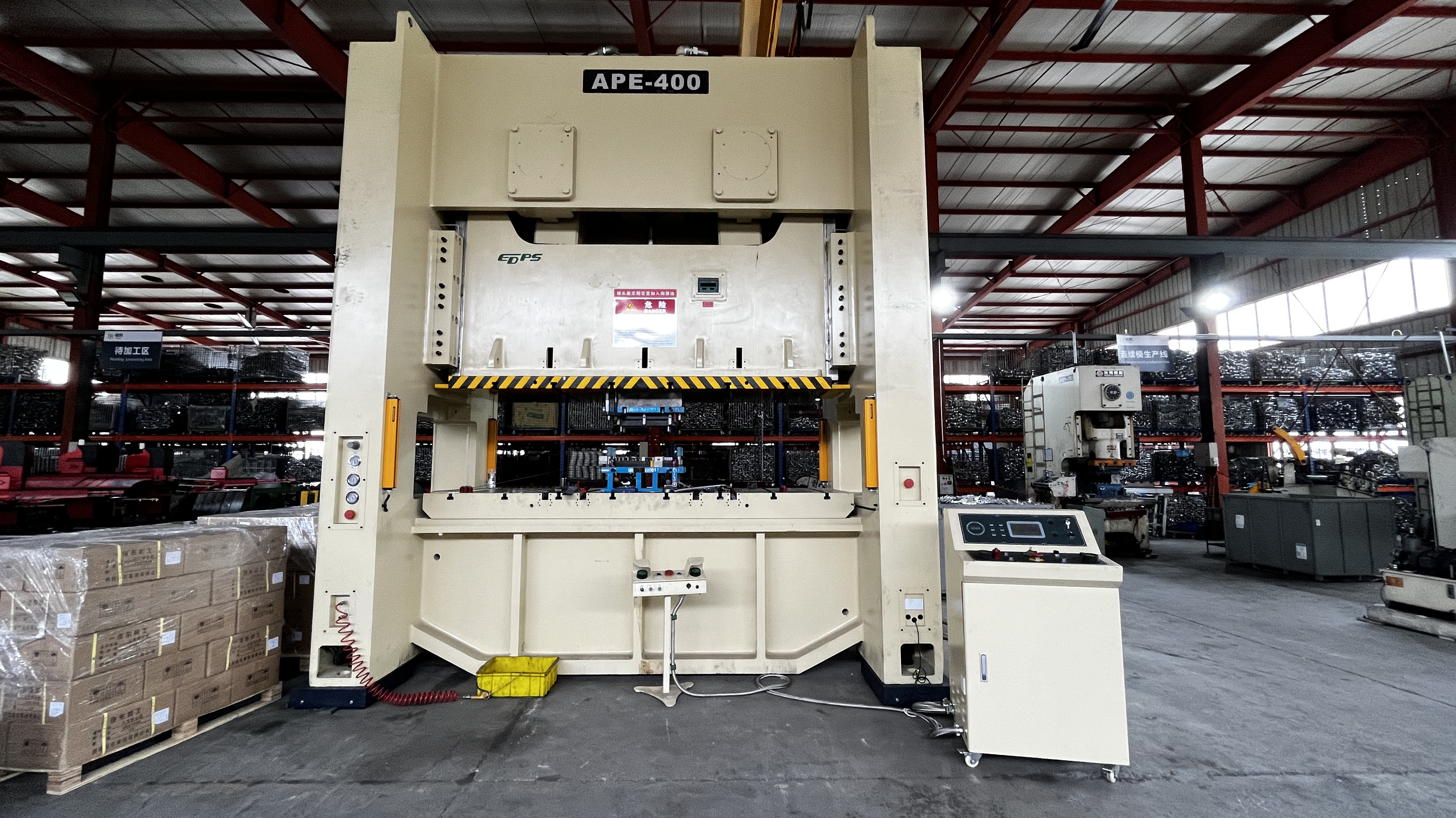 operator adjusting a stamping press and die set in a modern manufacturing facility
