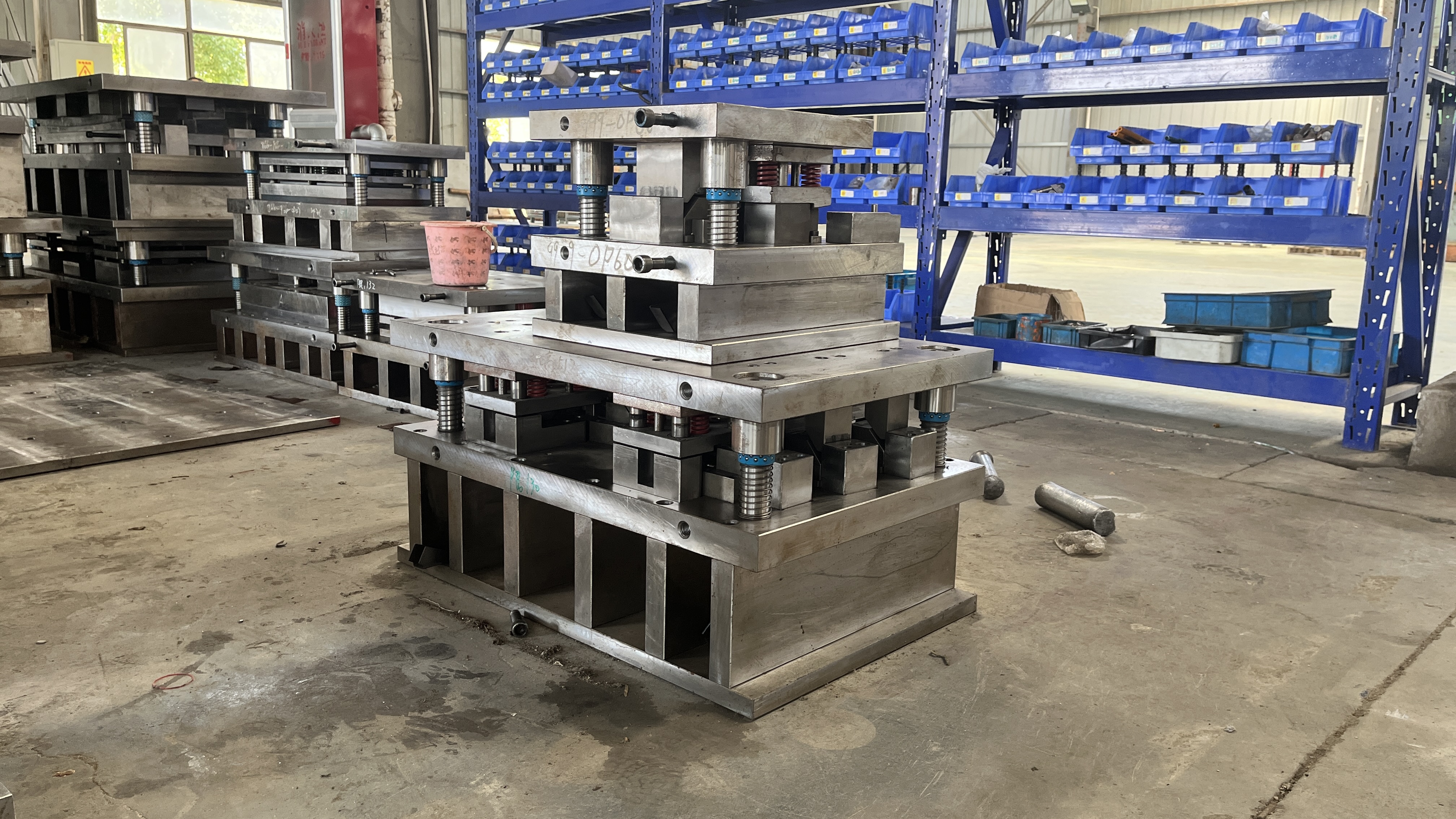 die stamping press and precision metal parts in an industrial workshop