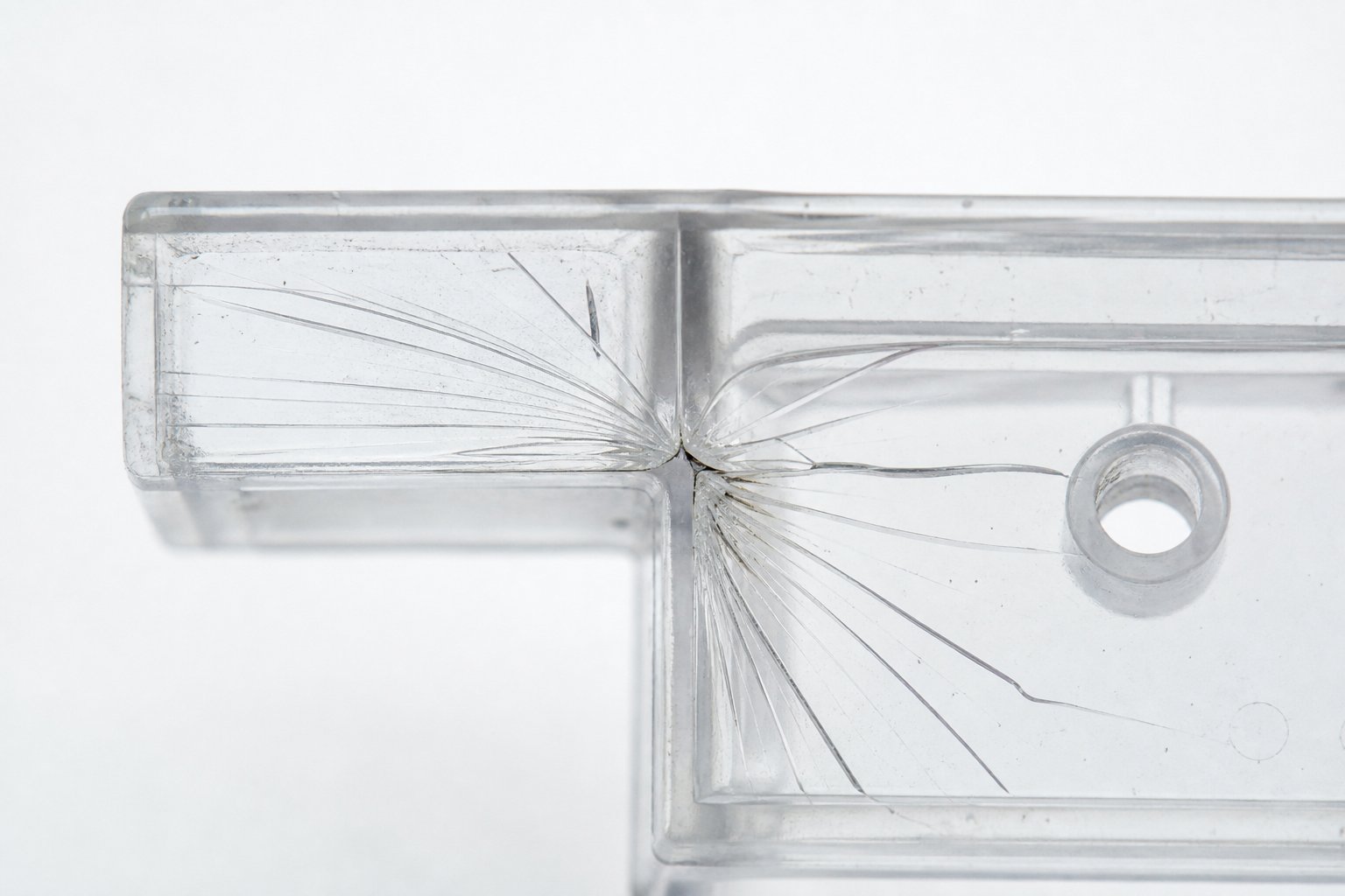 stress cracking in an engineering plastic part caused by sharp internal geometry acting as a stress concentrator under load